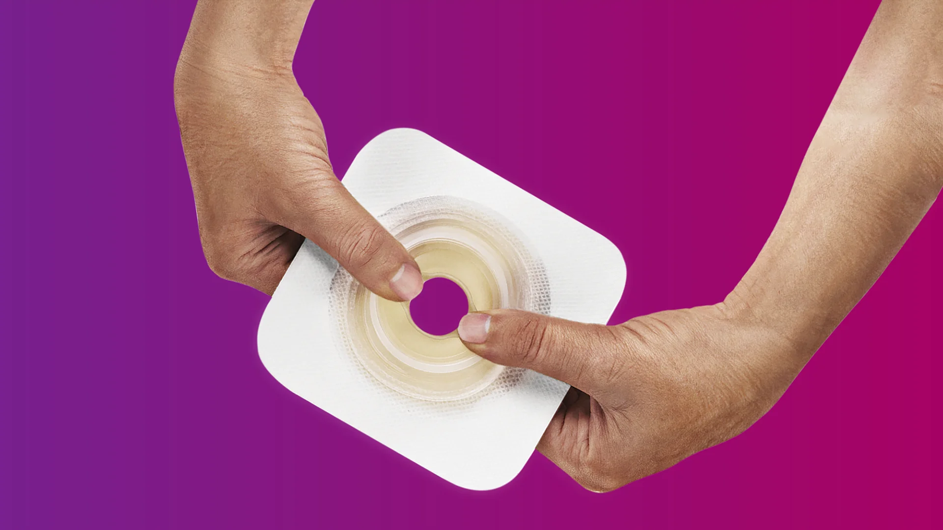 a close-up of hands holding a skin barrier