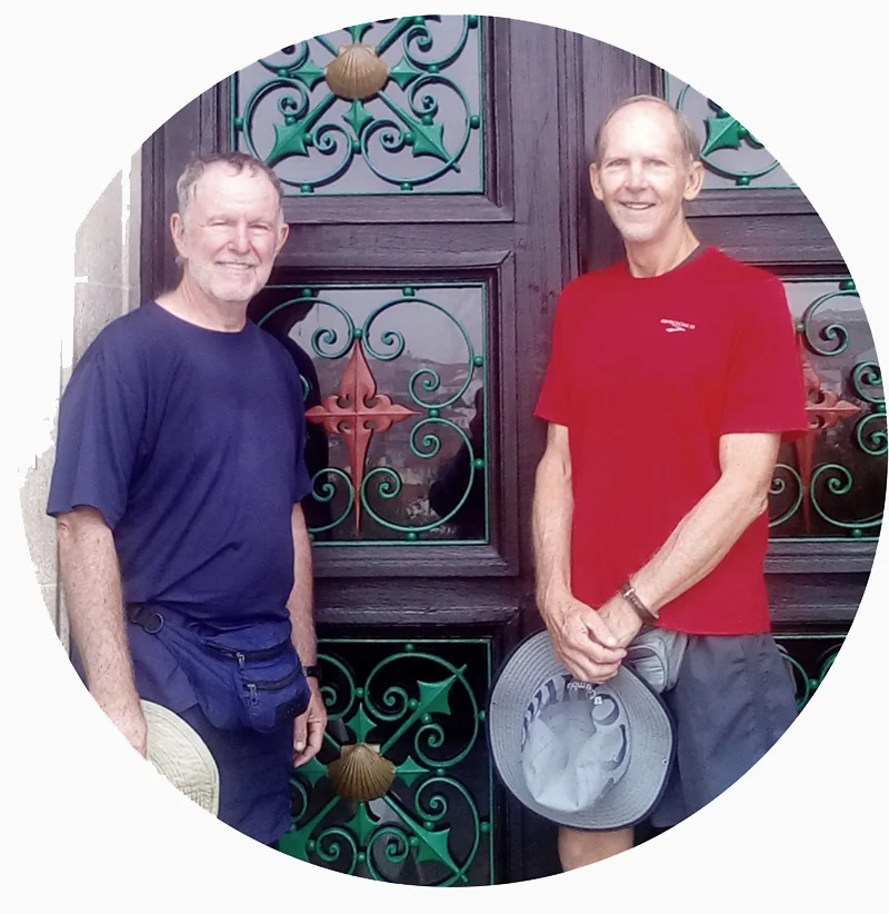 two men standing in front of a door with art on it
